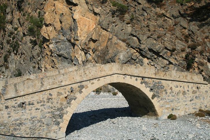 Stone bridge across a dry river bed in Agia Roumeli, Crete, Greece.  Image: Wikimedia